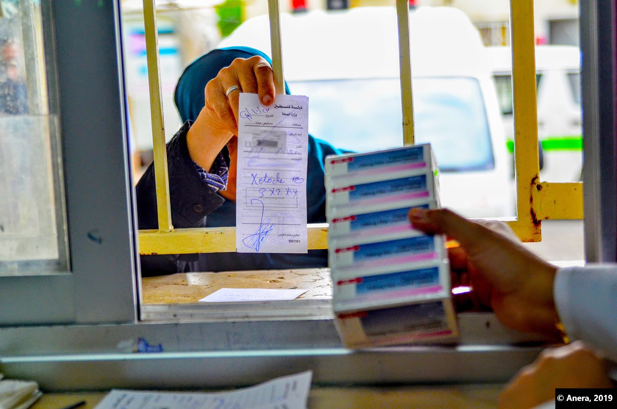 Woman filling prescription. Donations of cancer and heart medicines help many people in Gaza.