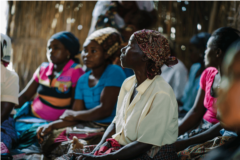 A group of women learn about TB and other health issues in a Care Group Meeting in Mozambique.