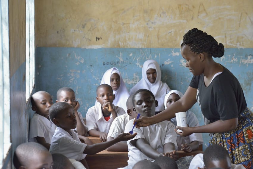 Woman distributes medicines for neglected tropical diseases in a mass drug administration in Tanzania.