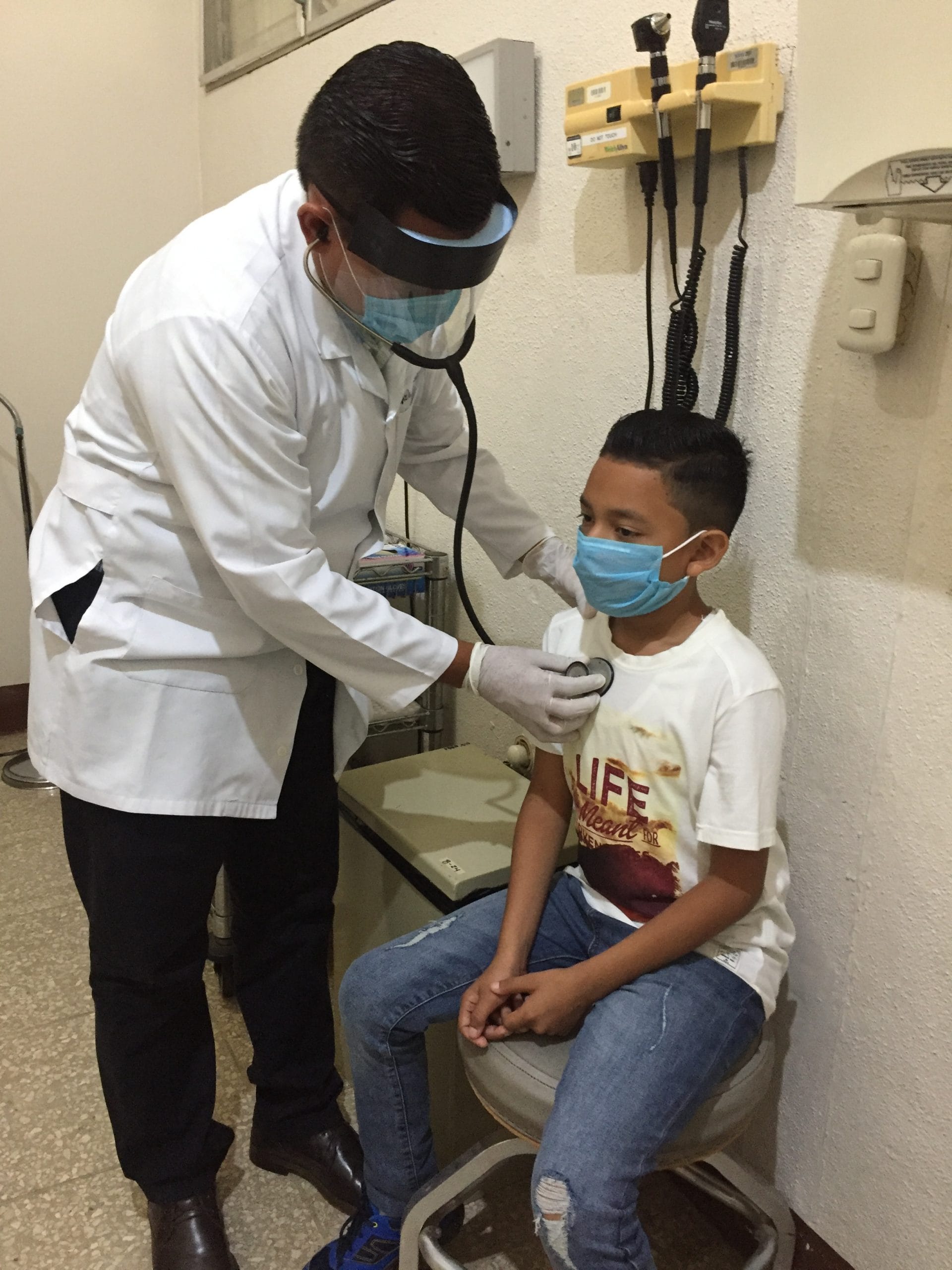 A doctor listens to the heart of a young patient at the Samaritan Clinic in Nicaragua.