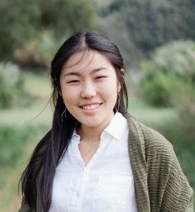 CCIH Intern Abigail Kim outside in among trees