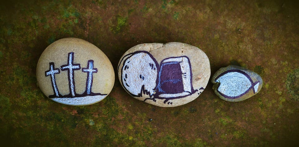 Three stones with paintings of three crosses, the open tomb and the symbol of early Christianity