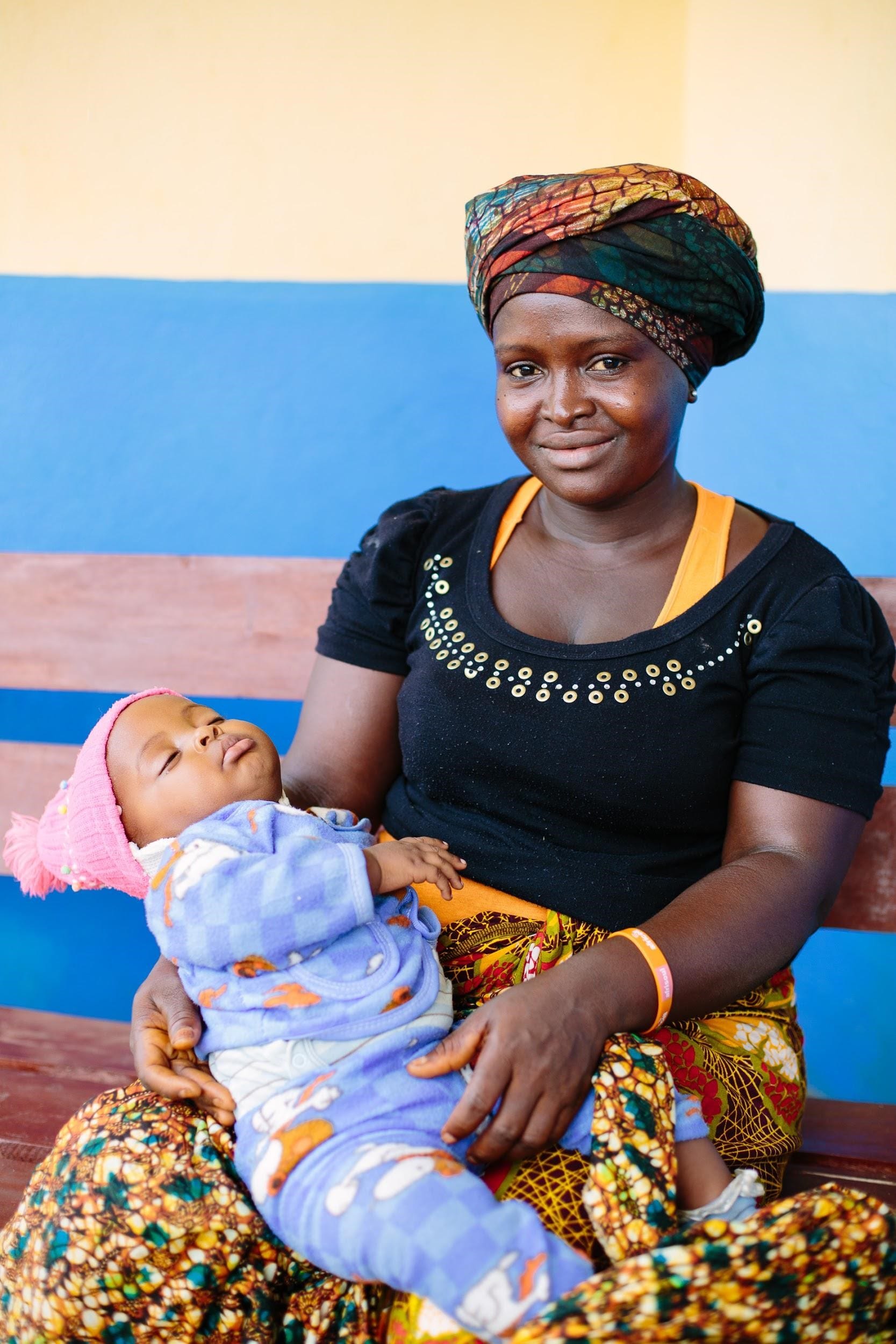 A woman holds an infant