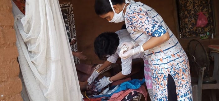 Doctor and nurse treat a patient in India