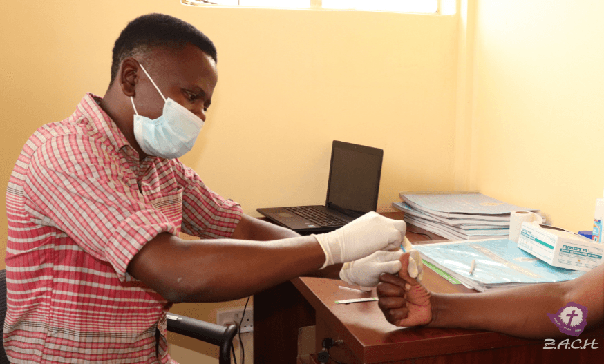 A man at a health post in Zimbabwe performs HIV testing.