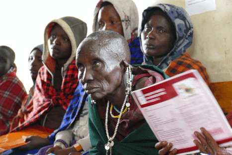 A woman who is a traditional birth attendant is surrounded by other women in Tanzania