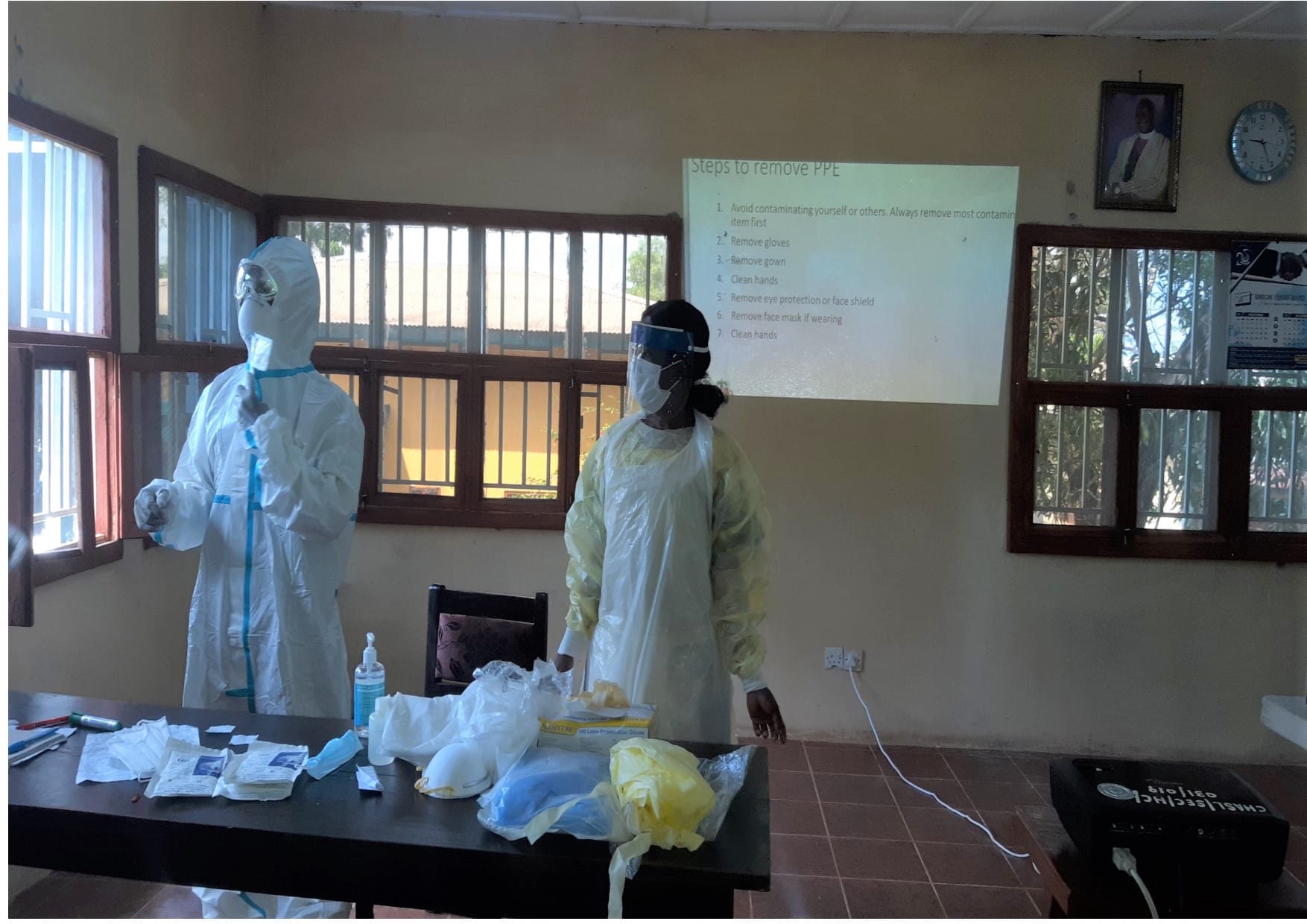 Health workers in Sierra Leone put on personal protective equipment, such as masks.